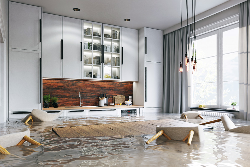 A flooded kitchen with chairs floating in need of flood cleanup near Patton, California.