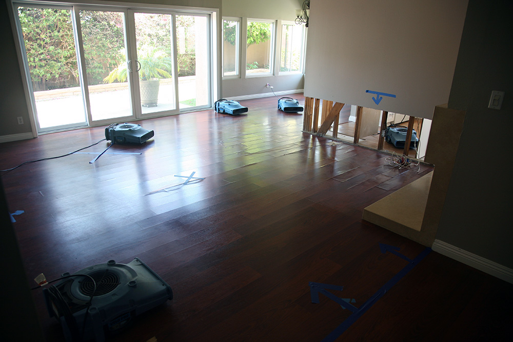 A wood floor being dried by multiple units as part of Redlands flood cleanup and restoration services.